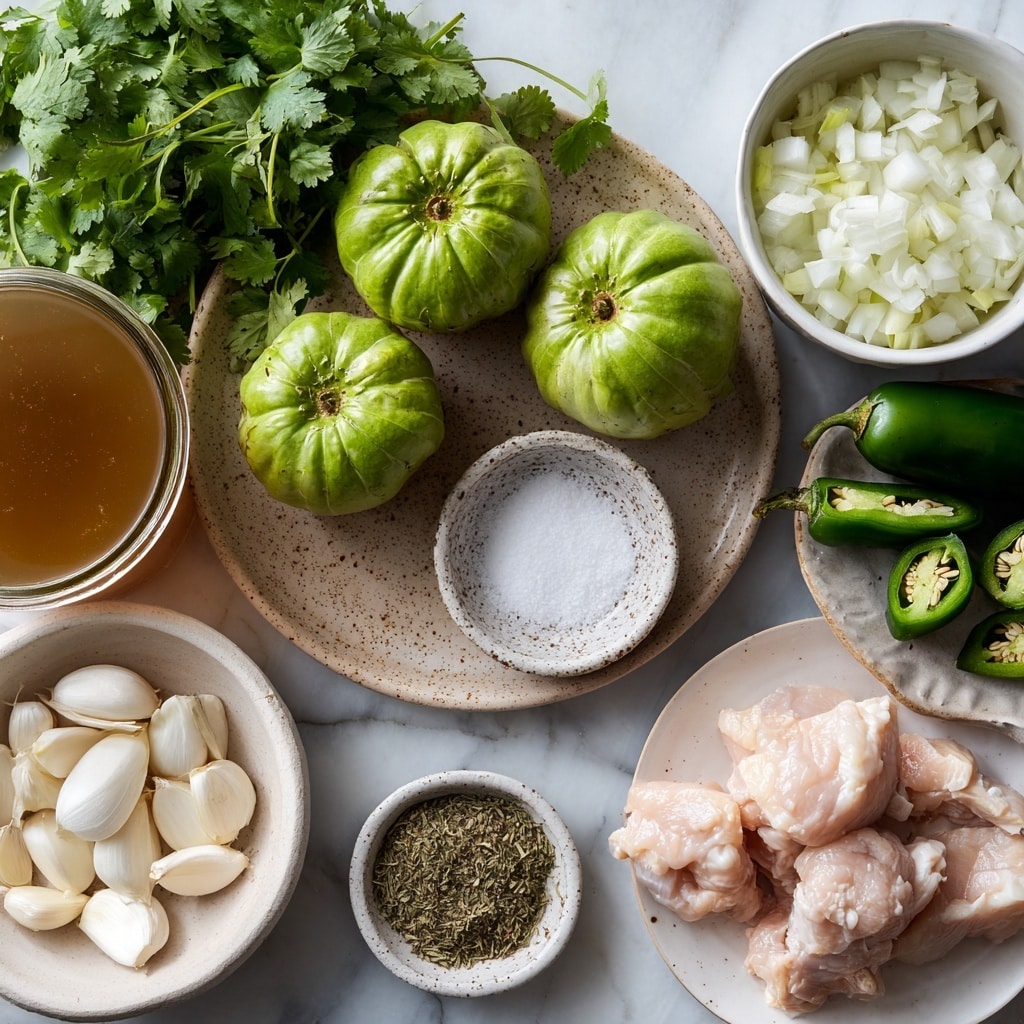 The image shows fresh ingredients for cooking arranged on a white marbled surface. There are four whole green tomatillos with a light shine, placed near a bunch of fresh green cilantro leaves on the left side. Three peeled garlic cloves sit on a small round plate with a speckled pattern near the center. Next to them is a small white bowl filled with white granulated salt. Above the garlic and salt is a white bowl filled with chopped white onion pieces. On the right side, there are several dark green jalapeño peppers, some whole and some sliced open to reveal white seeds inside. A beige bowl holds dried Mexican oregano, placed near the jalapeños. At the bottom left, a white bowl contains large white hominy grains. A large transparent jar with light brown broth is partly visible on the far left. At the bottom right, a white plate holds several raw chicken pieces with a pale pink color and slight fat edges. The whole scene is clean, bright, and organized in a way that clearly shows each ingredient's color and texture photo taken with an iphone --ar 4:5 --v 7