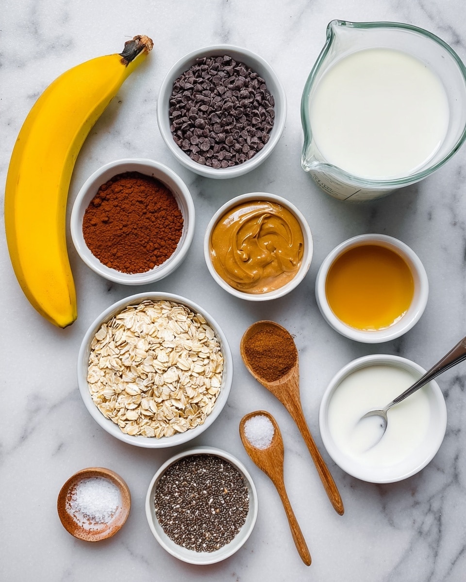 A bright yellow banana lies on a white marbled surface next to eight small white bowls and a clear glass measuring cup. The bowls hold dark brown cocoa powder, black chocolate chips, golden liquid honey, light brown peanut butter, small black chia seeds, rolled oats, thick white yogurt, and light amber liquid with a silver spoon inside. Two small wooden spoons sit on the surface; one holds a brown spice powder and the other holds white salt crystals. The clear glass measuring cup is filled with white milk. photo taken with an iphone --ar 4:5 --v 7