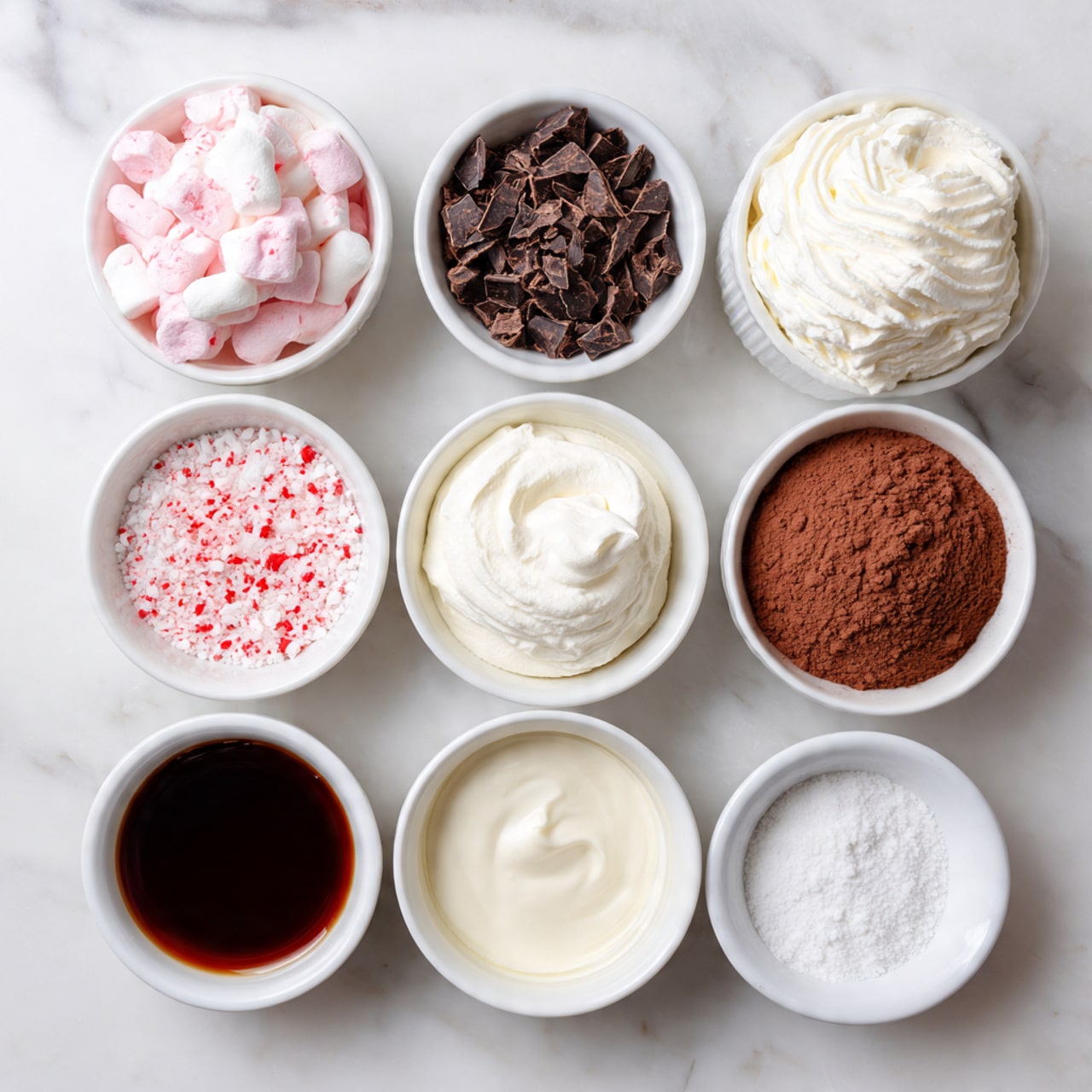 A tall red mug filled with steaming hot chocolate sits on a white marbled surface, topped with a big swirl of white whipped cream that heaps above the rim. Small pieces of crushed candy canes with white and red stripes are sprinkled all over the whipped cream and scattered lightly on the surface around the mug. The mug has a smooth, slightly shiny texture with a richer red handle on the right side. In the blurred background, a white ceramic jar and a white bowl filled with whole red candy canes add a festive feel. photo taken with an iphone --ar 4:5 --v 7