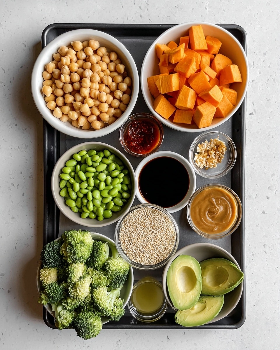 The image shows a black tray placed on a white marbled surface, holding several white bowls with different ingredients. Starting from the top left, there's a bowl filled with round, beige chickpeas. To its right, a bowl has bright orange cubed sweet potatoes. Below and near the center, there is a small bowl with a dark soy sauce, next to it a tiny bowl with minced garlic, and another small bowl with a reddish hot sauce. On the tray's bottom left, there's a bowl of green edamame beans, next to a bowl with light yellow oil. To the bottom right, a grey bowl contains fresh green broccoli florets, placed beside half of a light green avocado with its pit removed. Near the bottom center of the tray, a bowl holds white quinoa seeds, and next to it, a bowl contains chopped green cilantro leaves. Near the soy sauce bowl, a glass bowl has thick brown peanut sauce. The overall color palette contrasts nicely with the white bowls and the vibrant ingredients. Photo taken with an iphone --ar 4:5 --v 7