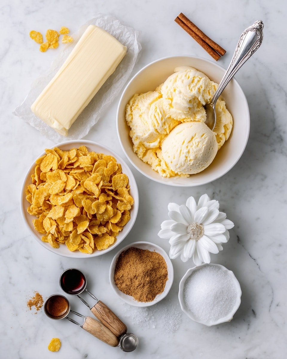 The image shows several ingredients arranged on a white marbled surface. There is a white bowl filled with golden yellow corn flakes, which have a dry and crisp texture. Above it, a white bowl of pale yellow vanilla ice cream with a smooth texture has a silver spoon scooping some ice cream. To the left of the ice cream is a stick of butter, pale yellow in color wrapped in paper. A small round white bowl holds brown cinnamon powder with a cinnamon stick laid on top. To the right of the cinnamon is a small white flower-shaped bowl filled with white granulated sugar. Below the sugar are two small silver measuring spoons with wooden handles, one filled with a dark vanilla extract and the other with white salt. All items are arranged neatly with clear textures and colors on the white marbled surface. photo taken with an iphone --ar 4:5 --v 7