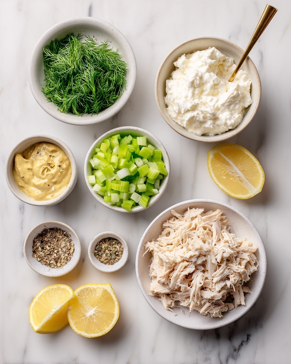 A white bowl filled with shredded chicken is placed on the bottom right of the scene. Above it, a larger white bowl holds smooth white cottage cheese with a gold spoon inside. To the left are smaller white bowls containing chopped green celery, finely sliced green onions, and fresh green dill. Near the top left, spice powders are arranged together without a bowl. A white small bowl at the bottom left holds creamy Dijon mustard. Two lemon halves with bright yellow rind and juicy, pale yellow insides are positioned near the center. All items are set on a white marbled surface, creating a clean and fresh look. Photo taken with an iphone --ar 4:5 --v 7
