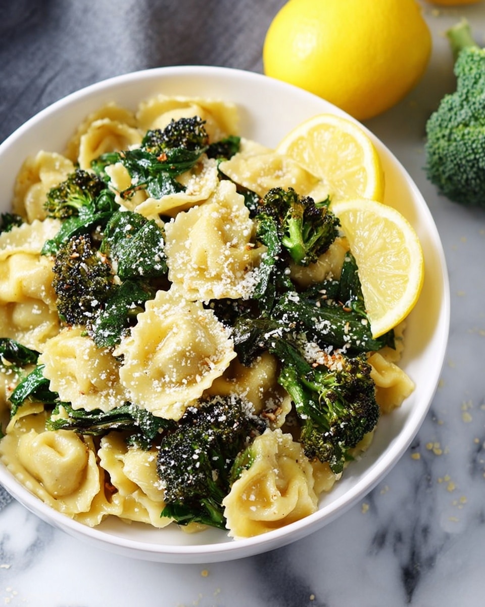 The dish is presented in a white bowl filled with light yellow pasta shaped like small pillows, layered with dark green wilted spinach leaves scattered throughout. Roasted broccoli florets with a mix of bright green and charred dark brown edges are placed evenly on top and throughout the pasta. A light sprinkling of finely grated white cheese powder covers the dish, adding texture. On one side of the bowl, a thin wedge of lemon with a pale yellow inside and bright yellow rind rests against the pasta. The bowl sits on a white marbled surface, with a silver fork inserted on one side. Photo taken with an iphone --ar 4:5 --v 7