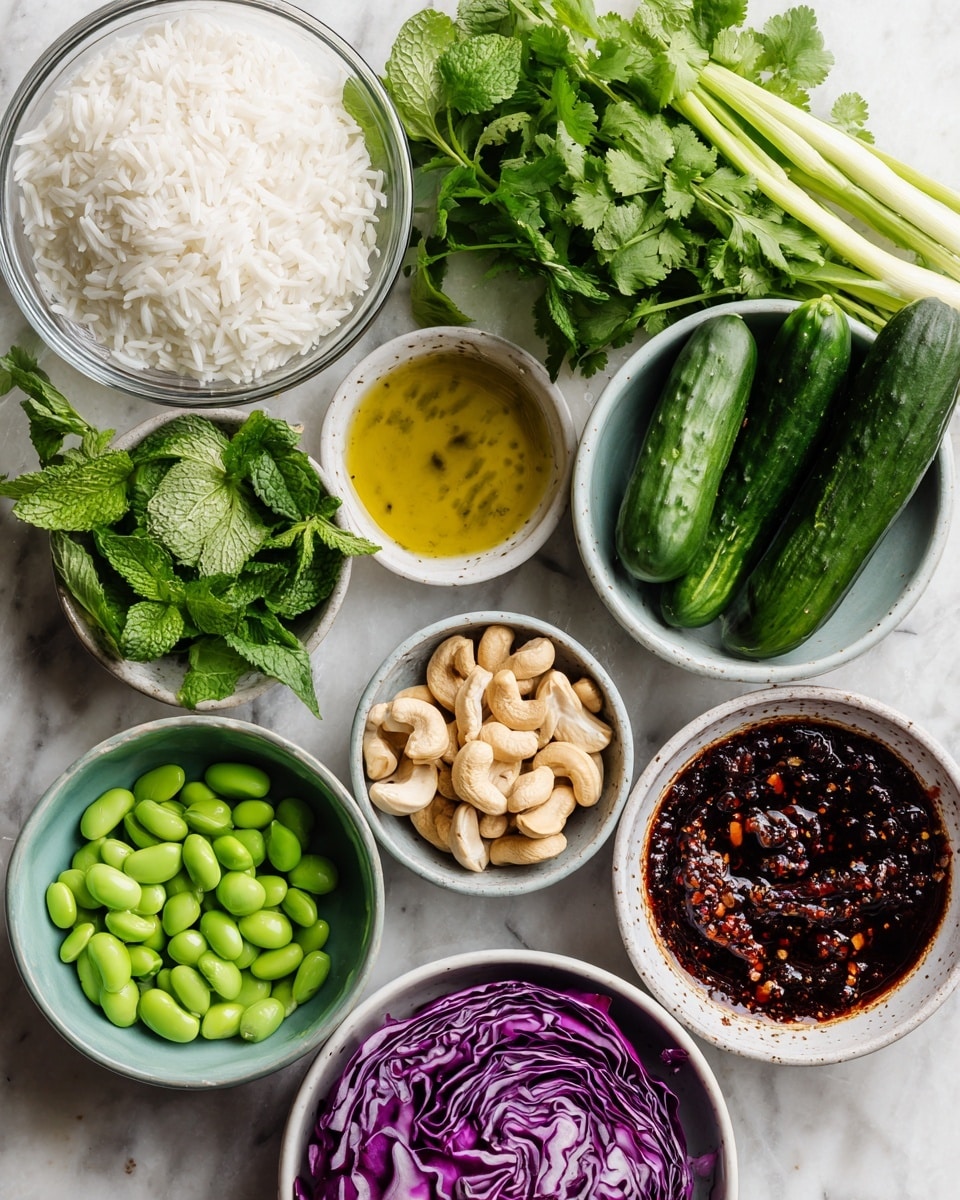The image shows fresh ingredients laid out on a white marbled surface. There is a clear glass bowl filled with white rice at the top left, and next to it fresh green cilantro leaves. Below the rice, a white small bowl holds golden sesame oil, and near it are bright green mint leaves and long green onions with white tips. A small gray bowl filled with light beige cashew nuts is placed near three dark green mini cucumbers. A white bowl full of vivid green edamame beans is at the bottom center. To the right, there is a deep purple red cabbage half with layered textures, and near it a white bowl with dark coconut aminos sauce. At the bottom right, a white bowl contains dark red chili crunch sauce with visible chili flakes. Everything is neatly arranged with clear labels identifying each ingredient. photo taken with an iphone --ar 4:5 --v 7