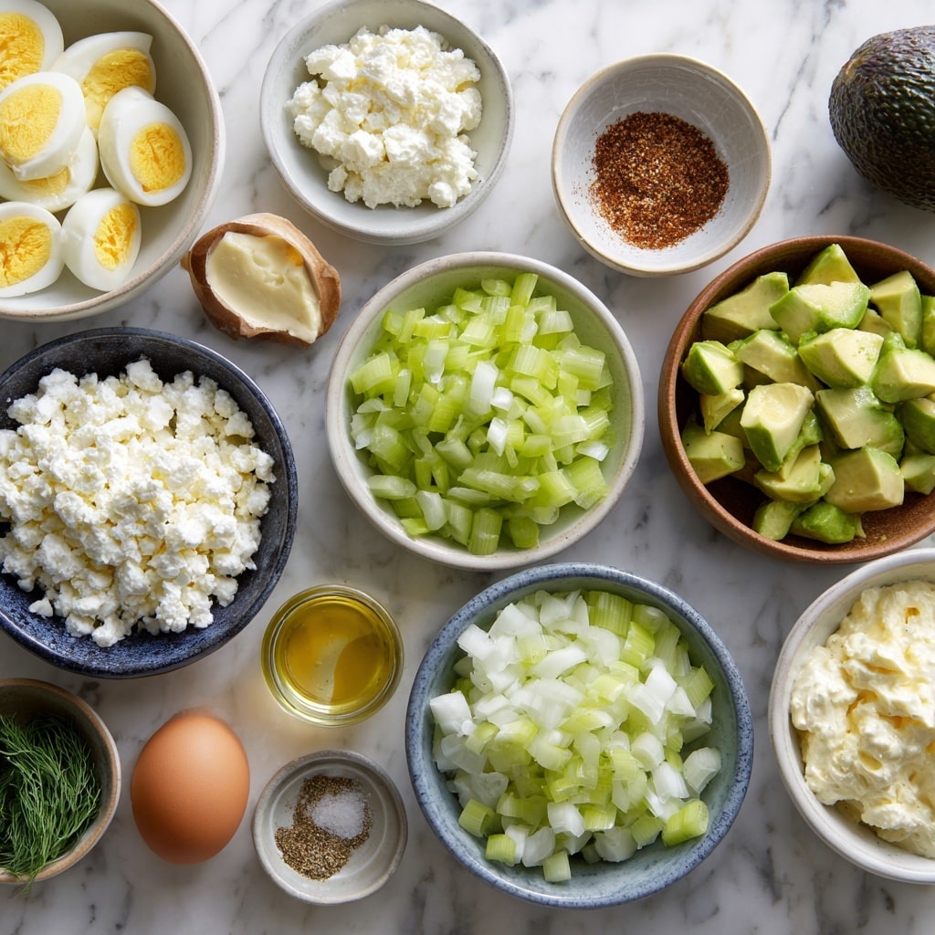 A wooden bowl filled with chunky egg salad mixed with creamy dressing and finely chopped green onions scattered evenly on top and within the salad, small specks of black pepper sprinkled across. The bowl sits on a white marbled surface next to half an avocado with its brown seed visible, along with some chopped green onions scattered in the background. A beige cloth is partly visible near the bowl. photo taken with an iphone --ar 4:5 --v 7