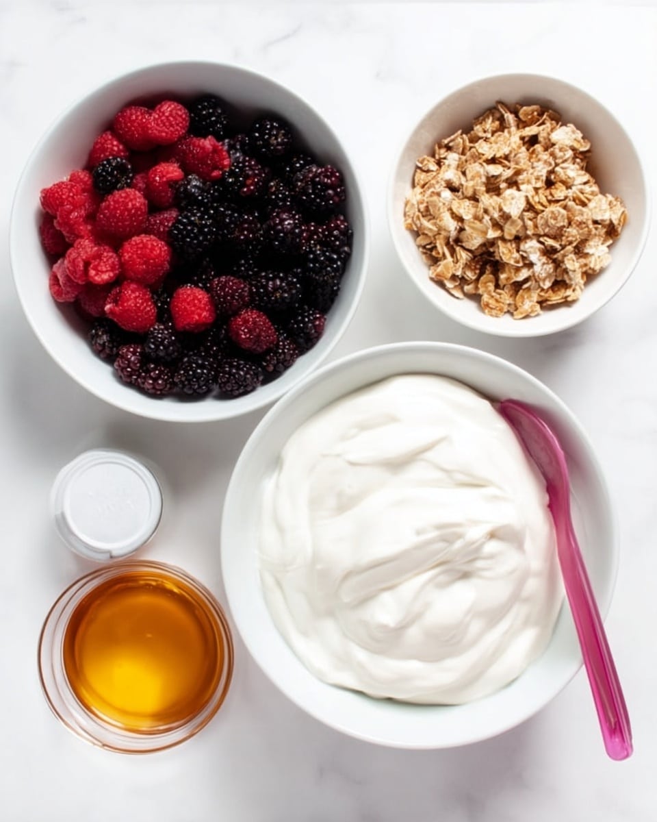 This image shows four white bowls on a white marbled surface, each containing different ingredients for a yogurt parfait. The largest bowl on the right holds thick, creamy white yogurt with a pink spoon resting in it. To the left, there is a medium white bowl filled with mixed berries, mainly blackberries and raspberries, that are dark red and purple in color. Above that, a smaller white bowl contains a light brown granola mix with a crumbly texture. Next to the granola bowl is a small white cup filled with golden honey, shiny and smooth. photo taken with an iphone --ar 4:5 --v 7