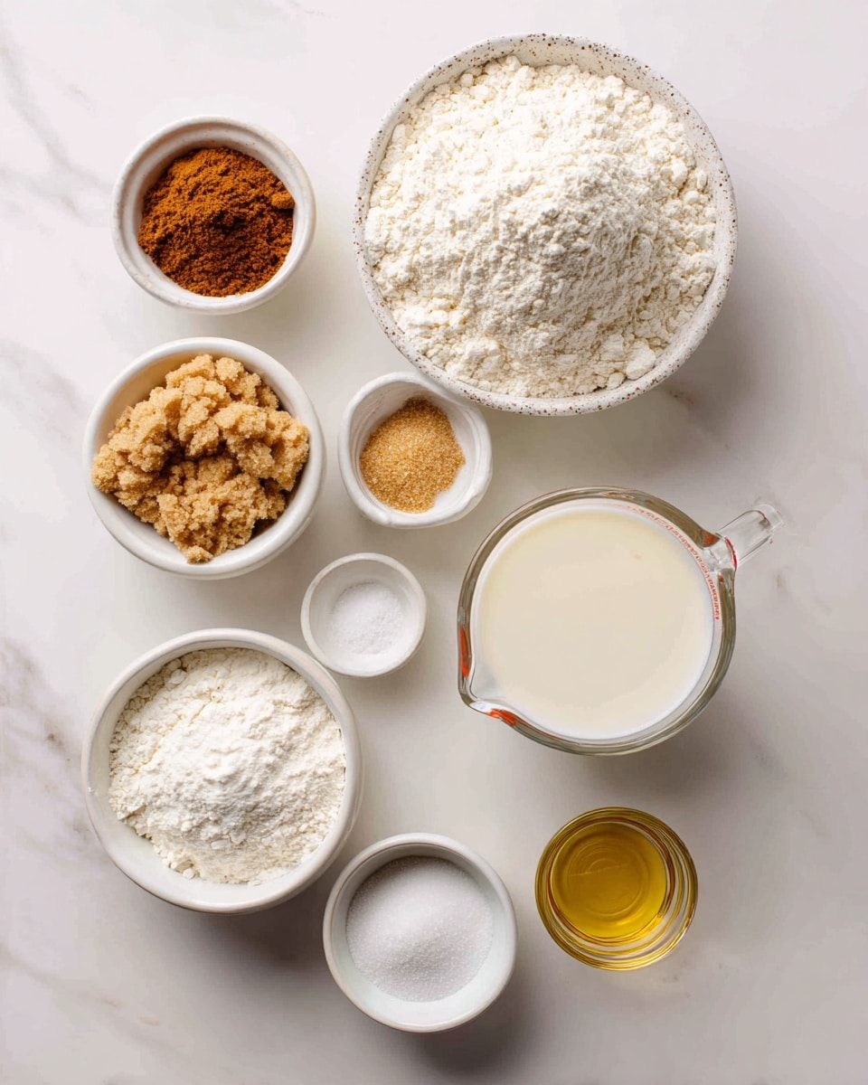 The image shows eight small containers with different ingredients neatly placed on a white marbled surface. In the center right, there is a speckled white bowl filled with a mound of white flour. To its top left is a small white bowl with ground cinnamon, brown in color with a fine texture. Below that, a small white bowl holds golden brown vanilla liquid. Under it is a white bowl filled with light brown brown sugar, clumped slightly. Below that is a white bowl with fine white sugar. Beneath the sugar is a small white bowl containing white baking powder and a tiny bit of salt. On the center right side, a clear glass measuring cup holds off-white dairy-free milk filling nearly to the top. Right below it is a small clear glass filled with light yellow oil. All items sit on a clean white marbled background. Photo taken with an iphone --ar 4:5 --v 7
