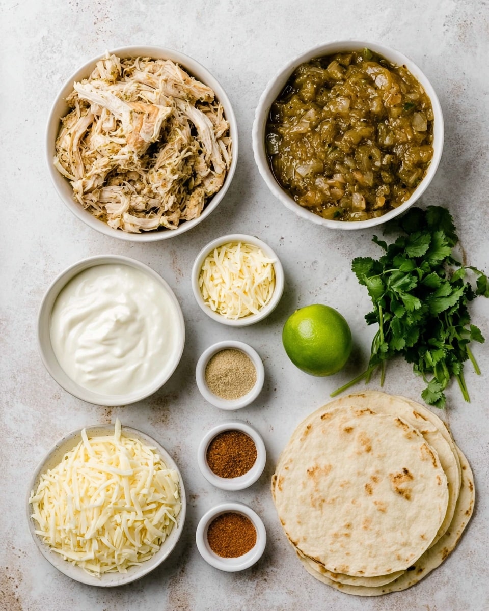 The image shows several white bowls and small white ramekins arranged neatly on a white marbled surface. In the top left, a white bowl is filled with shredded chicken mixed with herbs and spices, giving it a light brown and greenish look. Next to it on the right is a white bowl with a thick chunky greenish-brown sauce containing small pieces of vegetables. Below these, there is a white bowl filled with smooth white sour cream and another white bowl with shredded pale yellow cheese. Around the bowls are five small white ramekins holding different spices: a reddish powder, a green-brown powder, a beige powder, and two lighter powders. A fresh bright green lime sits near the center, and to the bottom right is a bunch of fresh green cilantro with leafy texture. Below and near the center is a small stack of light beige flour tortillas with light brown spots on top. The whole setup is clean and orderly on the white marbled surface. Photo taken with an iphone --ar 4:5 --v 7