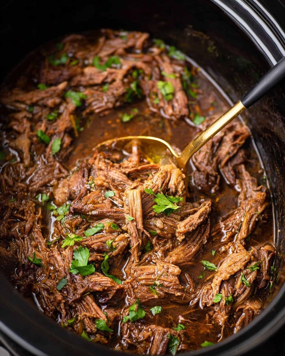 The image shows a close-up of shredded cooked meat soaked in dark brown juice inside a black slow cooker. The meat pieces have a soft texture with fibrous strands visible, mixed with small bright green parsley leaves scattered on top for color. A golden ladle with a black handle is partially submerged in the meat, positioned near the upper center of the dish, gently lifting some of the meat. The shot is taken from above, focusing closely on the rich details of the cooked meat and herbs, with a dark background emphasizing the dish. Photo taken with an iphone --ar 4:5 --v 7