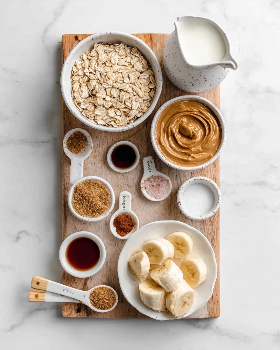The image shows a wooden board placed on a white marbled texture surface with several white bowls and spoons arranged neatly on it. On the top left, there is a white bowl filled with light beige rolled oats. Next to it on the right is a small white bowl with a swirl of creamy peanut butter in a light brown color. Below the peanut butter bowl is a white pitcher with a speckled pattern holding white milk. Towards the bottom right, there is a white bowl containing several thick slices of frozen banana with a frosty light yellow color. Around the board are three small white measuring spoons with beige handles, filled with pink salt, ground cinnamon, and a dark thick syrup. Next to these spoons, there is another small white bowl filled with light brown sugar, and above it is a small white bowl with a dark amber syrup. A few oats are scattered on the white marble near the board. photo taken with an iphone --ar 4:5 --v 7