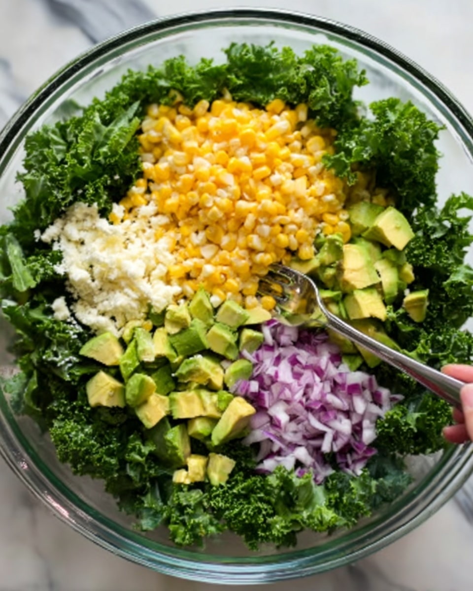 A clear glass bowl sits on a white marbled surface, filled with fresh green kale leaves forming the base layer. On top of the kale, there are small separate piles: bright yellow corn kernels, finely chopped white cheese, diced light green avocado, and small pieces of finely chopped purple onion. The colors are vibrant and the textures range from leafy and soft to chunky and crumbly. A woman's hand holds a metal fork resting on the edge of the bowl. Photo taken with an iphone --ar 4:5 --v 7