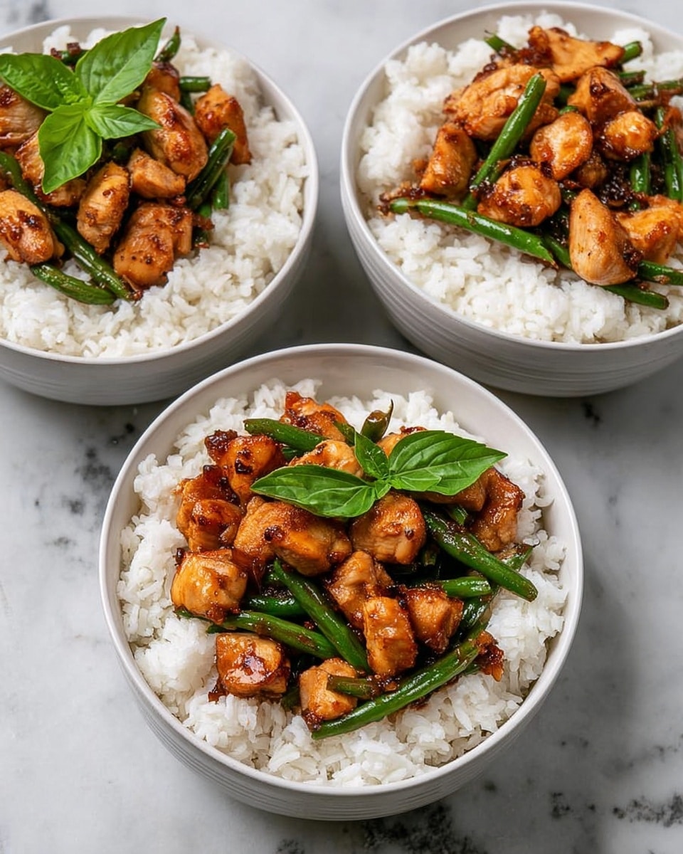Three white bowls filled with cooked white rice form the base layer in each; the rice looks fluffy and soft. On top of the rice in each bowl is a layer of golden-brown cooked chicken pieces, showing a slight glaze and light char marks. Mixed with the chicken are green beans, the beans bright and fresh, adding a green contrast. A few fresh green basil leaves crown the center bowl's chicken and beans, giving a pop of fresh color. The bowls are set on a white marbled surface. photo taken with an iphone --ar 4:5 --v 7