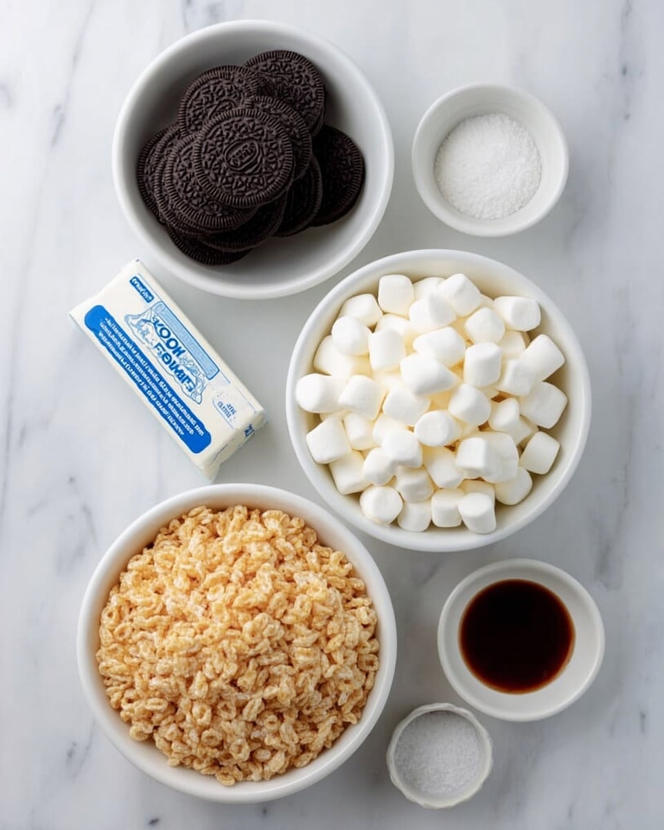 The image shows six ingredients placed on a white marbled surface. At the top is a white bowl filled with stacked black sandwich cookies, with one cookie lying next to the bowl. Below that is a white stick of butter with blue text on the wrapper. Beneath the butter is a large white bowl full of small white marshmallows. Next to the marshmallows, on the right, are two small white bowls, one containing a dark brown liquid and the other with white granulated salt. At the bottom is another large white bowl filled with crispy rice cereal, light brown in color. All the items are neatly arranged in a vertical line. Photo taken with an iphone --ar 4:5 --v 7