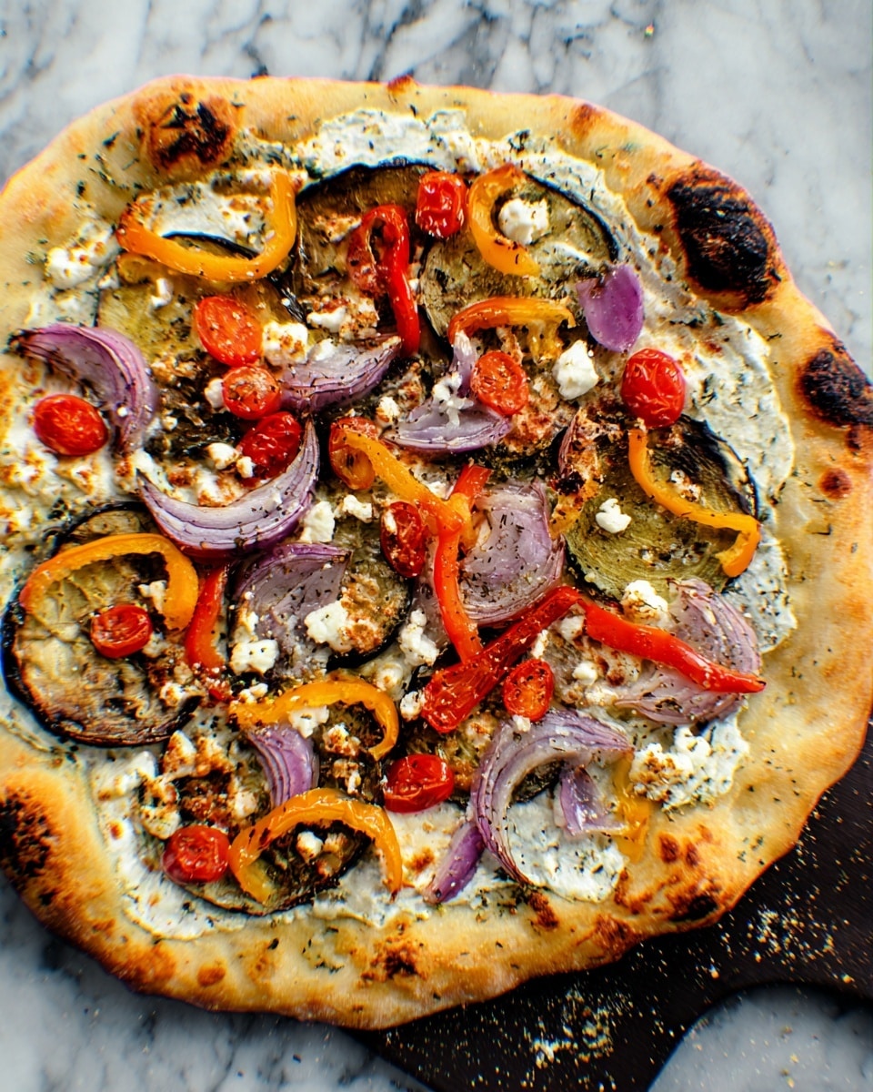 A round pizza with golden brown crust, slightly uneven with some charred spots along the edges, sits on a dark baking tray. The pizza has a thin layer of creamy white sauce spread unevenly on the base. On top, there are slices of roasted eggplant, bright orange and yellow bell pepper rings, halved cherry tomatoes, and purple rings of red onion scattered around. Crumbled pieces of white cheese are dispersed across the surface, and some parts have small bits browned from baking. The pizza is on a white marbled surface. photo taken with an iphone --ar 4:5 --v 7